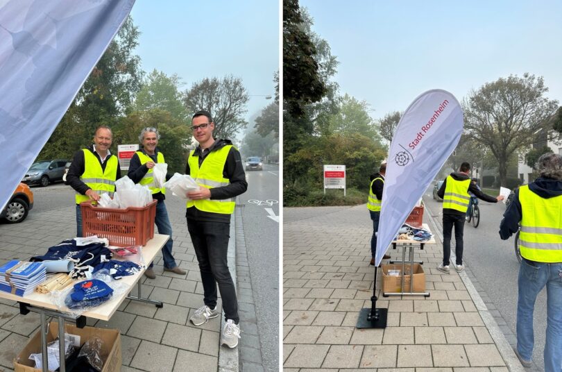 Thomas Gems, Olaf Fröhlich und Daniel Zuleger beim Verteilen von Brezen an Radfahrende. – Stadt-Rosenheim-Fahne und Mitarbeitende bei der Übergabe von Brezen an Radfahrende in der Küpferlingstraße.