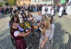 Kirwamadla stoßen mit geschmückten Krügen an.