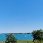 Blick auf die Herreninsel und den See bei sommerlichem Wetter.