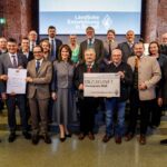 Die Vertreterinnen und Vertreter der Sieger des Staatspreises 2026: 1. Reihe v.l.n.r.: Franz Langstein (Verein für das Erinnern), Maximilian Heimerl (Landrat Mühldorf a. Inn), Sebastian Gaigl (ALE OB), StMin Michaela Kaniber, Dr. Heinz Utschig (BaySF a.D.), Balthasar Baumann (ALE OB), M.d.L. Sascha Schnürer, Martin Hartinger (BaySF); 2. Reihe v.l.n.r.: Heinrich Baumert (Verein für das Erinnern), Tobias Gehrmann (ADBV Mühldorf a.Inn), Edin Hamberger (Verein für das Erinnern), Dr. Jascha März (Stiftung Bayerische Gedenkstätten), Korbinian Baumann (Geschichtszentrum Mühldorf a.Inn), Monika Löffelmann (BaySF), StM a.D. Dr. Marcel Huber, Josef Grundner (1. Bgm. Ampfing), Josef Eisner (1. Bgm. Mettenheim), Barbara Donaubauer (ALE OB), Thomas Einwang (1. Bgm. Markt Buchbach)