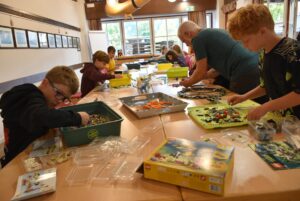 Im Lesesaal bauen Kinder und Jugendliche gemeinsam an ihren Modellen.